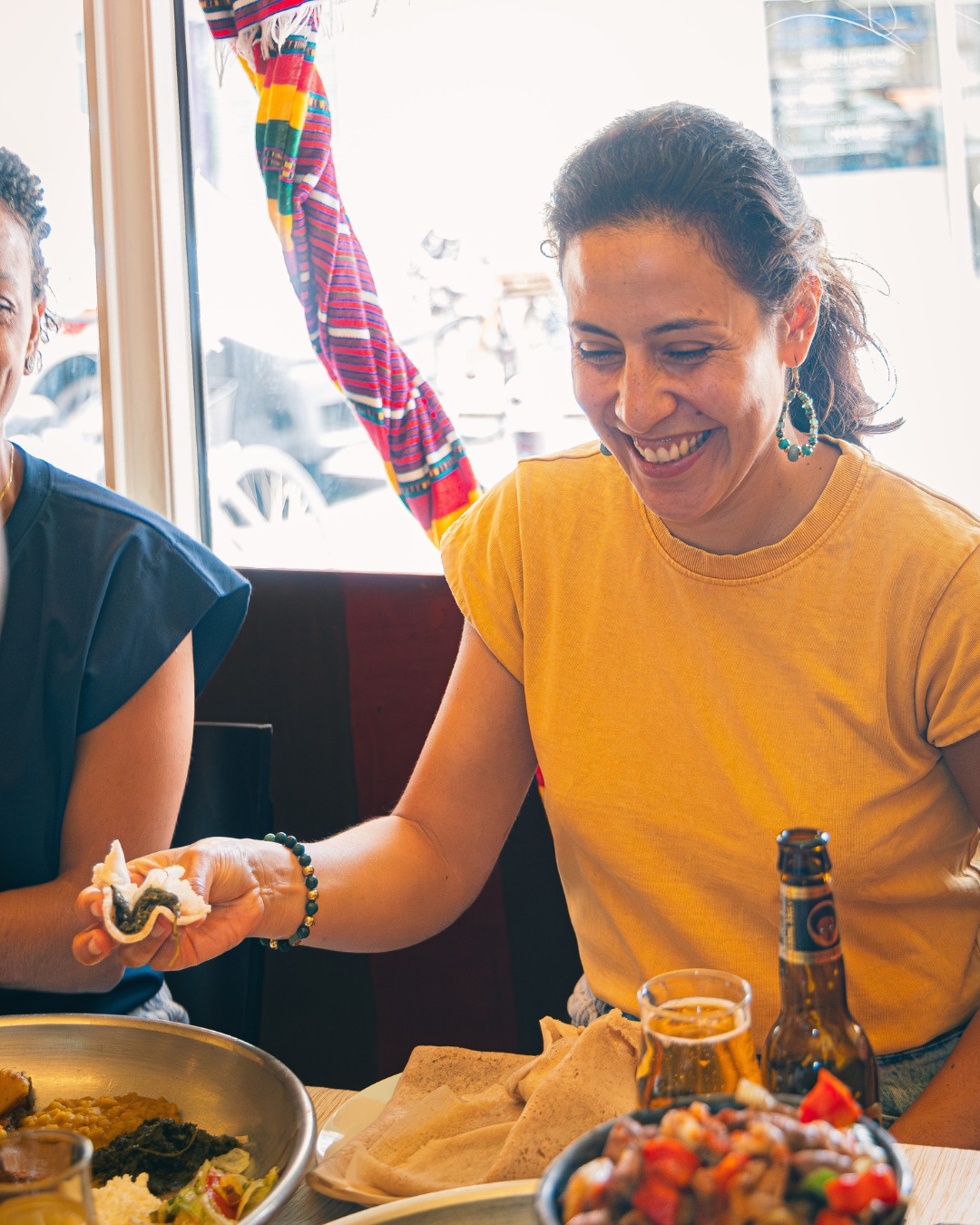 Un moment de partage à table, l'injera offerte à la main